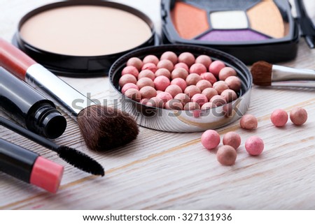 makeup brush and cosmetics make up artist objects: lipstick, eye shadows, eyeliner, concealer, nail polish, powder, tools for make-up