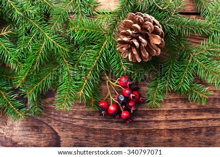 Christmas fir tree with decoration on dark wooden board. Top view horizontal. Mock up for design greeting card. Selective focus.
