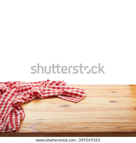 Red checked tablecloth on wooden deck table on white background. Mockup for design