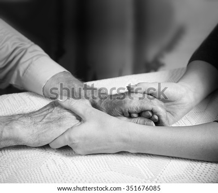 Care is at home of elderly. Senior man, with their caregiver at home. Concept of health caring for elderly old people, disabled. Elderly man. Black and white photo