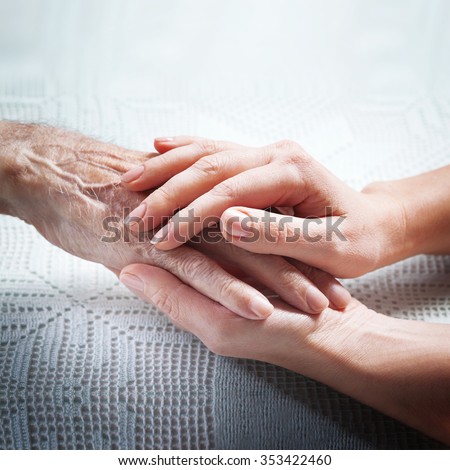 Helping hands, care for the elderly concept. Care is at home of elderly.