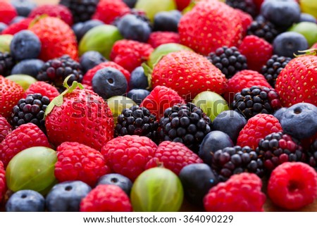 Berries Background macro, selective focus. Raspberries appetizing, natural blueberry, juicy strawberries, ripe gooseberries. Fruit Mix like bright background