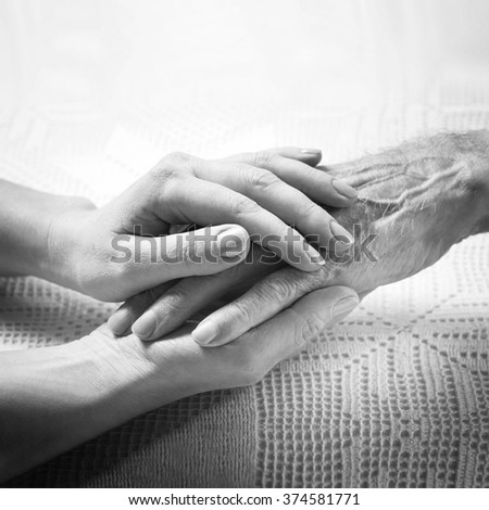 Helping hands, care for the elderly concept, man\'s hands black and white\
,