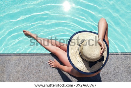 Beautiful woman sunbathing by the pool top view horizontal. Summer background. Poster, mock up for design.