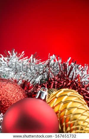 christmas accessories and spheres on red background