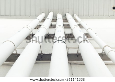 Workers are water pipes with PVC joints Elbow allows the split to the left or right, which must penetrate concrete walls to make PVC pipe coming out the other side of the building.