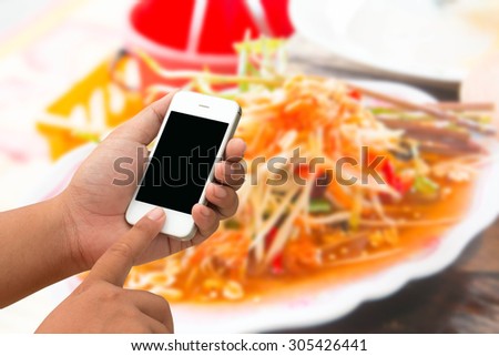 Mobile men and touchscreen smartphone, tablet, mobile phone on the table for lunch.