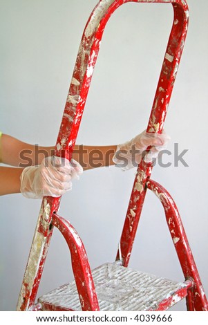 Young woman climbing on a step ladder