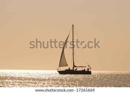 People on a sail boat at the sunset