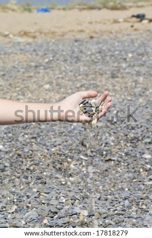 The girl pours out a pebble from a hand