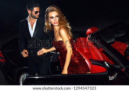 Couple in luxury car. Night life.