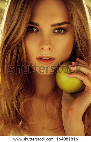 Picture Of Young Beautiful Woman With Green Apple. Sexual Beauty Girl In Autumn Garden Of Apples