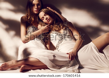 Blonde twins in white dresses morning