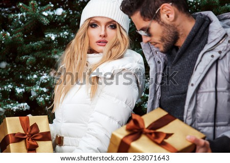 Christmas Gift. Happy Couple with Christmas and New Year Gift