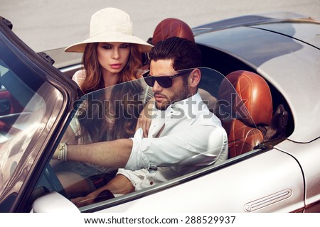Sexy couple in the car. Luxury life.