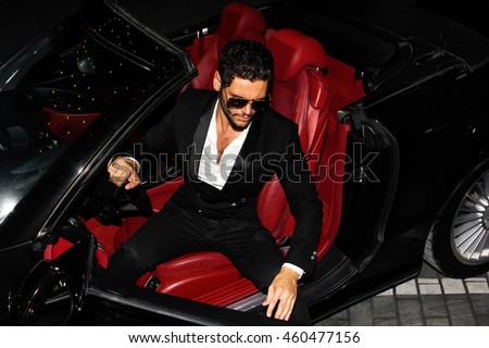Men in luxury car. Night life.