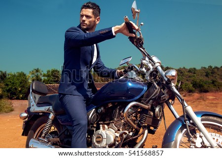 Man on motorcycle in suite