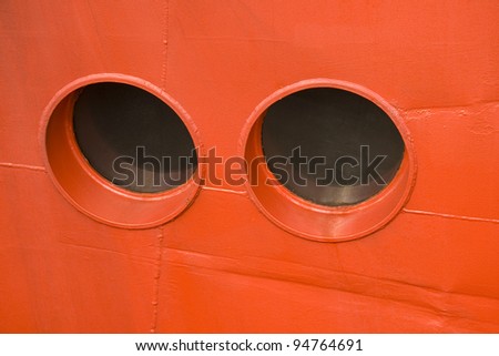 Close-up on port-holes on a red ferry. Can be used as background