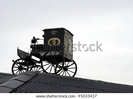Old horse driven carriage on the roof at a baker\'s store