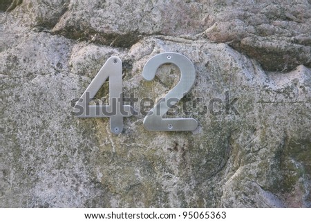 House number 42 on a small rock