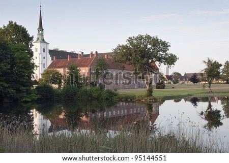 The manor house Brahetrolleborg with reflections in a lake