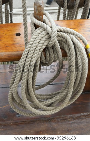Ropes on belaying pin on board a tall ship