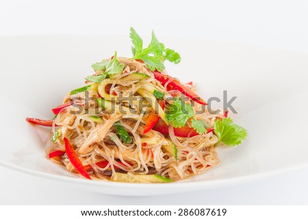 Close up Tasty Asian wheat noodles with pork, vegetables and herbs on white plate isolated on white background
