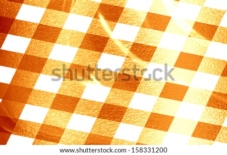 orange picnic cloth with some squares in it