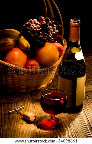 Bottle vine and a basket of fruit covered by light on a table