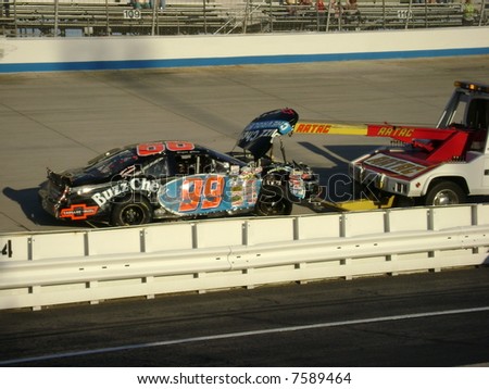 the 99 car being towed away from a crash at dover