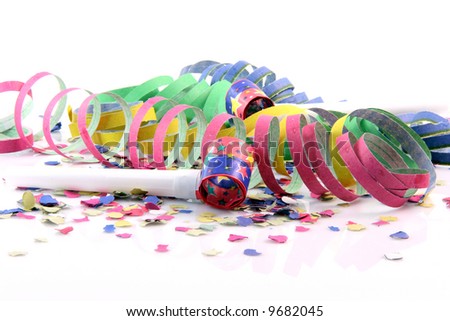 holidays and party time paper confetti with streamers and party blowers on white background