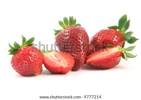 group of strawberries close-up one is cut in half isolated on white background healthy eating