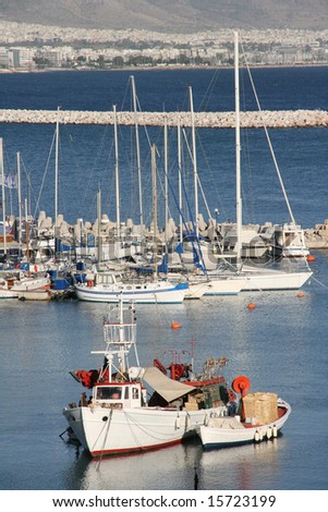 fishing boats and sail yachts in marina at piraeus athens greece vertical