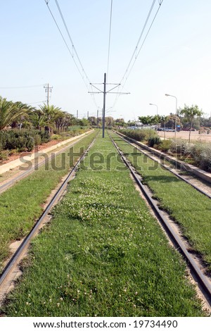 nature and transportation electric railway with grass and plants environmental friendly