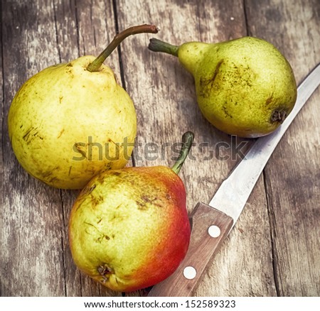 Three ripened and fragrant pears on the wooden table