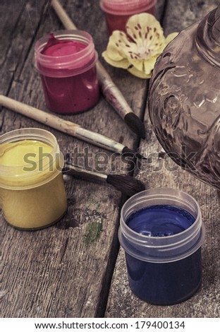 paints and paint brushes in the old processing
