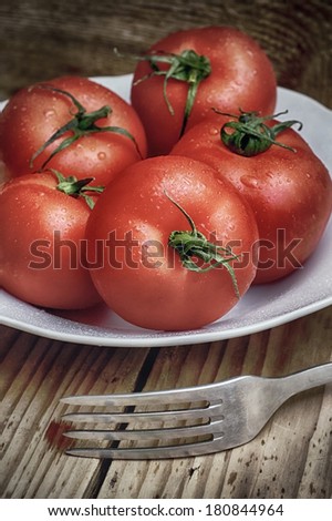 spring crops of tomatoes on the background of wood