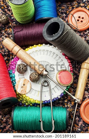 thread,button,crochet hook, and other sewing tools