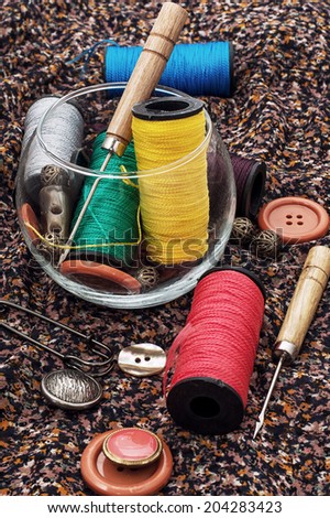 thread,button,crochet hook, and other sewing tools