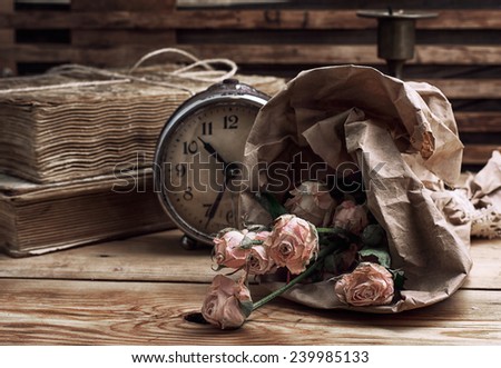 retro composition with a bouquet of roses and old-fashioned clock