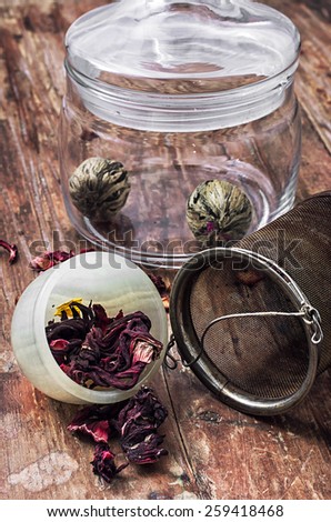 different varieties of brewed leaf tea in glass jar. The image is tinted in vintage style