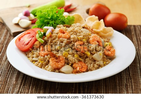Asian fried rice nasi goreng with chicken, prawns, and fish baso