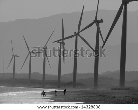 children playing under the power windmills of bangui bay, philippines