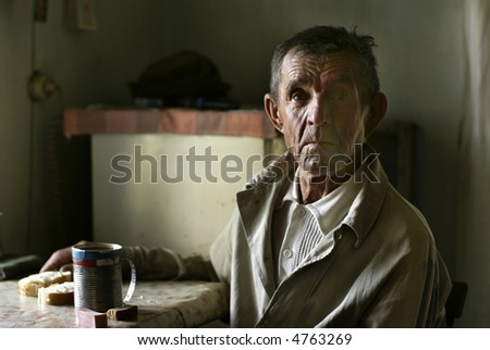 Portrait of old farmer on the table