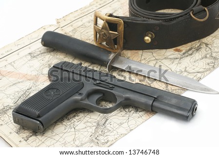 Soviet army scouts ammunition. Composition with hand gun TT (model 1943), standard army scouts knife, soviet officer belt and old army map. Period of the Second World War