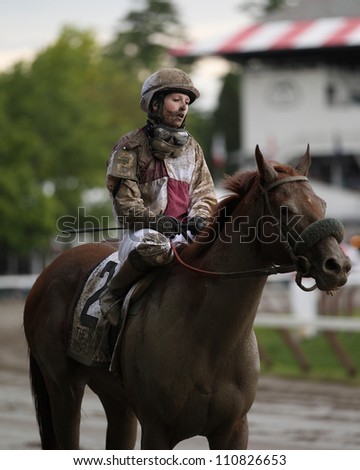 SARATOGA SPRINGS, NY - JULY 28: An exhausted Jockey Rosie Napravnik aboard Fast falcon after the Jim Dandy Stakes on July 28, 2012 Saratoga Springs, New York