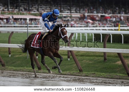 SARATOGA SPRINGS, NY - JULY 28: Jockey Ramon Dominguez aboard Alpha runs out after winning the Jim Dandy Stakes on July 28, 2012 Saratoga Springs, New York