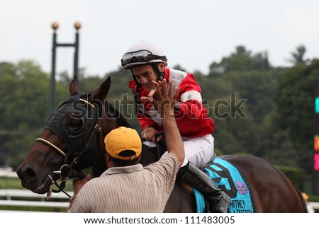 Saratoga Springs NY - AUGUST 4: Jockey Brian Joseph Hernandez, Jr. aboard Fort larned congratulated by groom after winning the Whitney Invitational on August 4, 2012 Saratoga Springs, New York