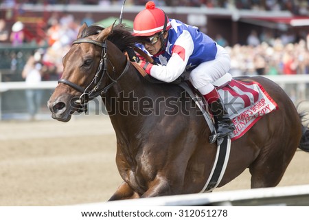 SARATOGA SPRINGS, NY - August 29, 2015: Runhappy ridden by Edgar Prado wins the King\'s Bishop Stakes on Travers Day at Historic Saratoga Race Course on August 29, 2015 Saratoga Springs, New York
