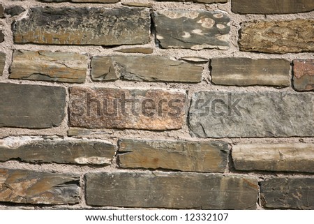 Medium Stones in Field Stone Wall on 18th Century Home for Background